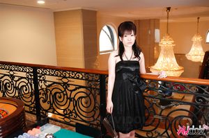 Beautiful Hina Kawamura in black dress enjoys a glass of champagne.