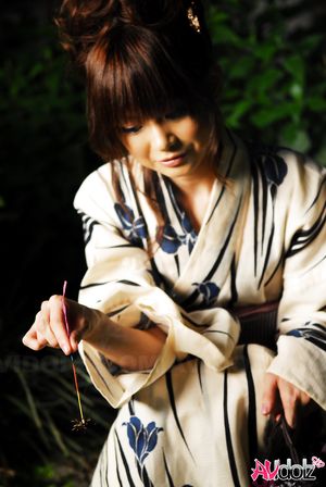 Anna Watanabe in kimono is cute playing with a firework outdoor.