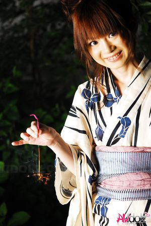 Anna Watanabe in kimono is cute playing with a firework outdoor.
