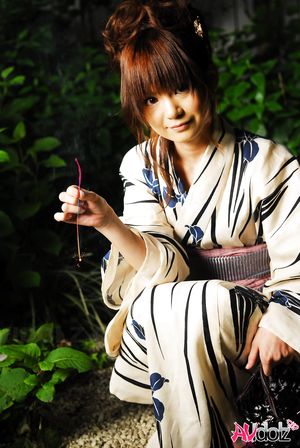 Anna Watanabe in kimono is cute playing with a firework outdoor.