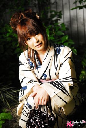 Anna Watanabe in kimono is cute playing with a firework outdoor.