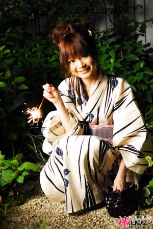 Anna Watanabe in kimono is cute playing with a firework outdoor.