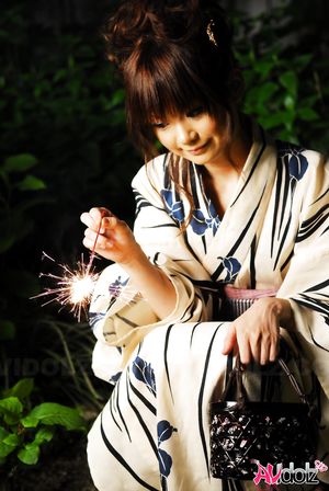 Anna Watanabe in kimono is cute playing with a firework outdoor.