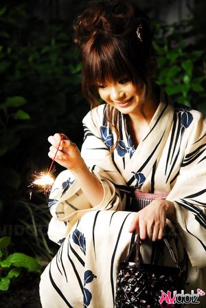 Anna Watanabe in kimono is cute playing with a firework outdoor.