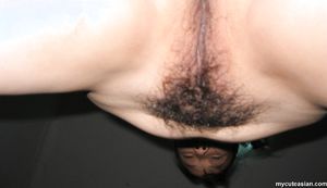 Naked Asian amateur wife opens her legs wide to show her hairy pussy