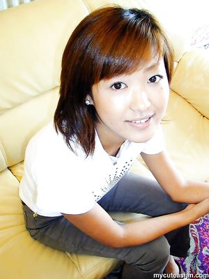 Horny asian amateur teen is stripping on the sofa and posing nude