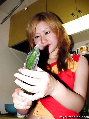 Naughty asian amateur teen puts carrot and cucumber in her tight pussy