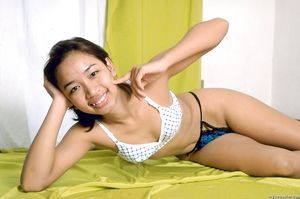 Young asian teen with small breasts spreads her tight hairy pussy