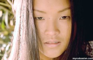 Long haired Asian beauty strips and opens wide her tight twat