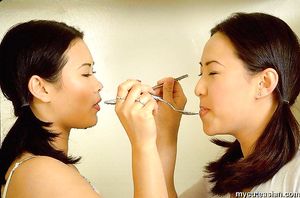 Two hot babes play with cream on their sexy bodies in kitchen