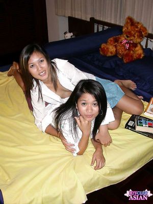 Two naked horny asian lesbians posing and give tender kisses