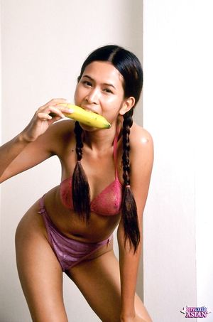 Naughty little asian slut eats banana and open her pussy wide