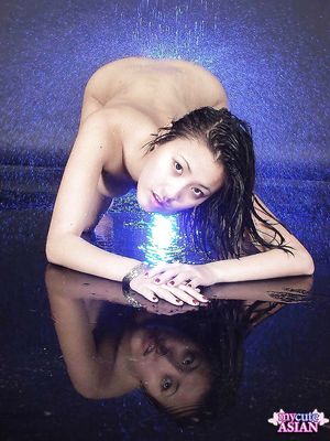 Horny asian babe showing her perfect boobs in a waterfall