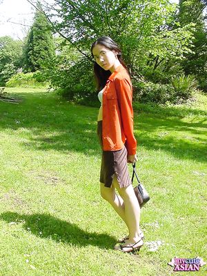 Long haired asian beauty shows her round tits in forest here