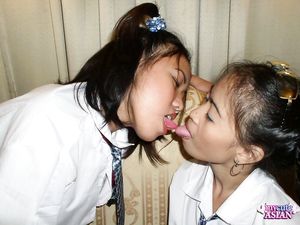 Two lesbian asian schoolgirls sucking and fingering each other