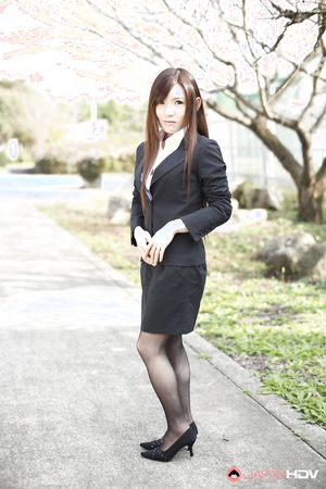 Naughty Hitomi Tsukishiro in office outfit poses so sexy outdoors.