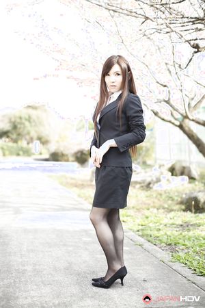 Naughty Hitomi Tsukishiro in office outfit poses so sexy outdoors.