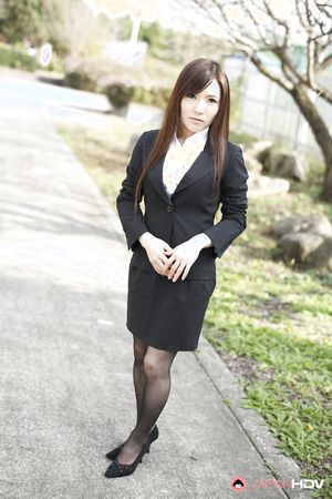 Naughty Hitomi Tsukishiro in office outfit poses so sexy outdoors.