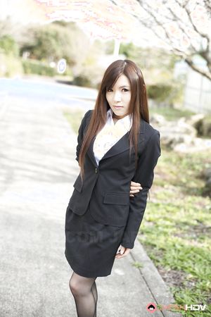 Naughty Hitomi Tsukishiro in office outfit poses so sexy outdoors.
