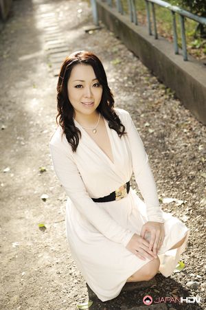 Asian Yuna Yamami in a white dress is very elegant and attractive.