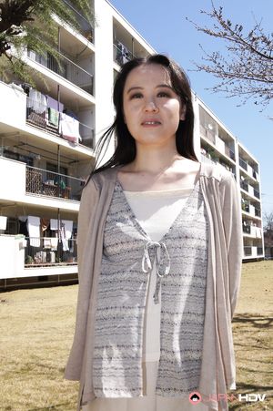 Junko Nishimura is an Asian lady presenting her new outfit outdoors.