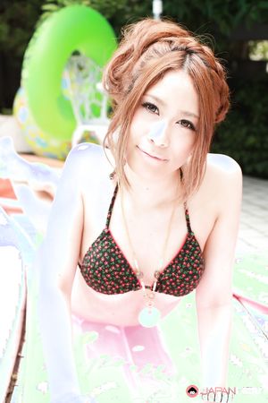 Adorable young Asian model showing her sexy curves by the pool