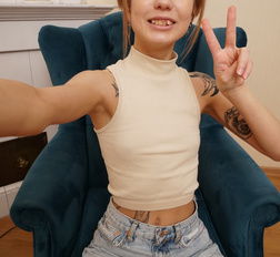 Skinny teen showing off her tattooed figure