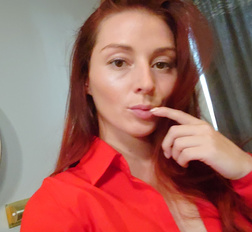 Naughty redhead reveals her big tits on cam