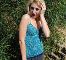 Blonde with tattoos does a striptease outside