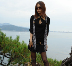 Naughty Rena shows her nude body in nature, at the ocean's shore.