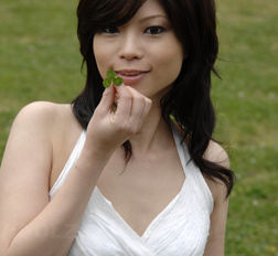 Asian Kurumi Katase in white dress is playful and happy in the nature.