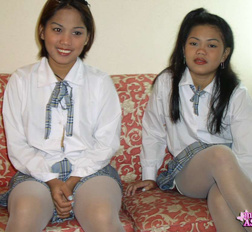 Two lesbian asian students fingering their wet shaved pussies