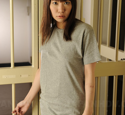 Slender brown haired Japanese babe shows her boobies in prison